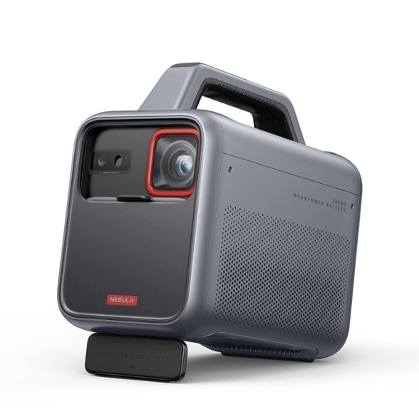 Anker Nebula Mars 3 portable projector set up in a backyard, displaying a movie on a large screen.