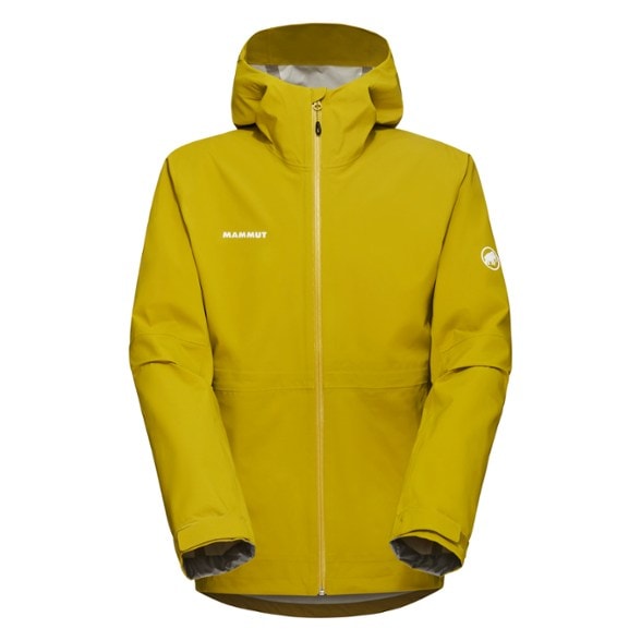 Mammut Linard Guide 3L Men's Waterproof Jacket in action on a mountain trek, showcasing its durable fabric and adjustable hood.
