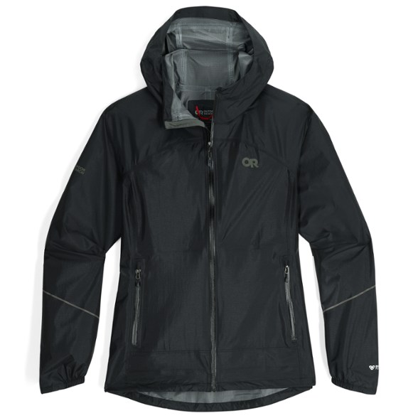 Trailblazer women's packable rain jacket in action on a hiking trail, showcasing its adjustable hood and lightweight fabric.