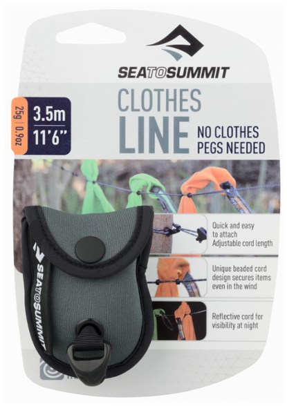 TrailLite travel clothesline shown stretched between trees on a campsite, ideal for compact outdoor use.