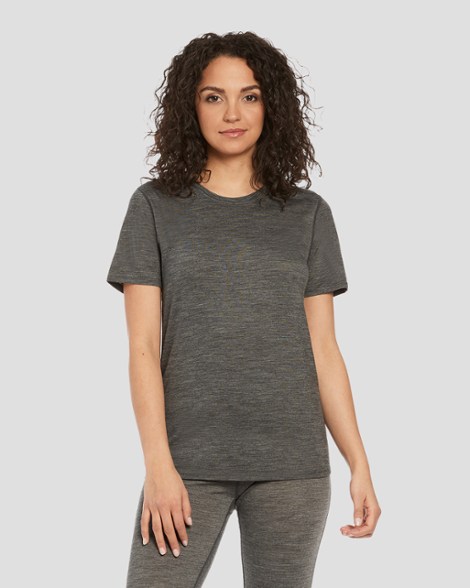 Front view of SummitFlow women's merino wool t-shirt worn by hiker on sunlit trail