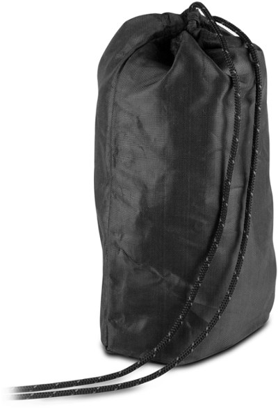 Close-up of TrailGuard X10 bear sack cinched tightly with Spectra cord, resting on forest ground.