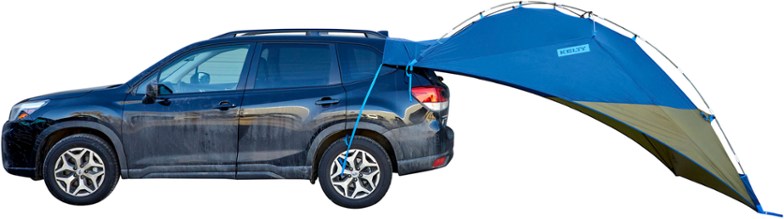 Side angle view of vehicle canopy mounted on a Sprinter van in forest setting