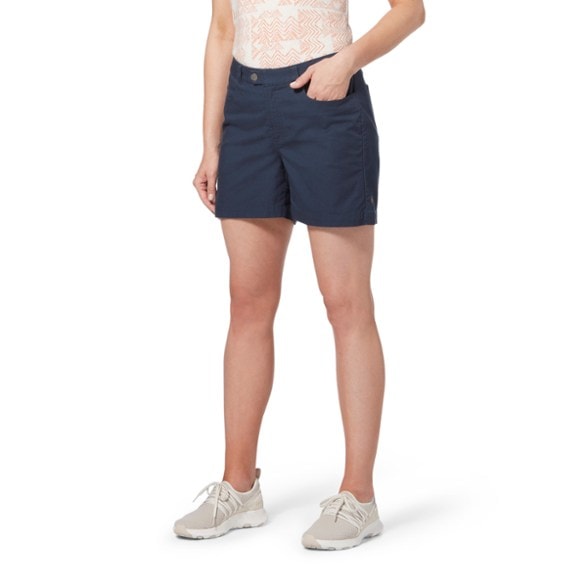 A woman hiking in the Adventure-Ready Women's Billy Goat II Hiking Shorts, showcasing flexibility and comfort.
