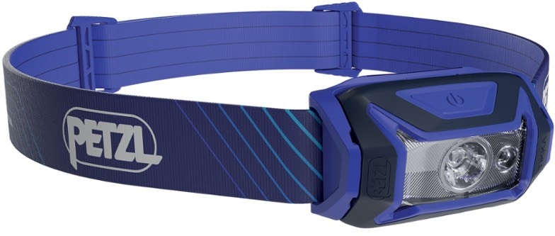 Petzl Tikka Core headlamp showing adjustable beam on a campsite.