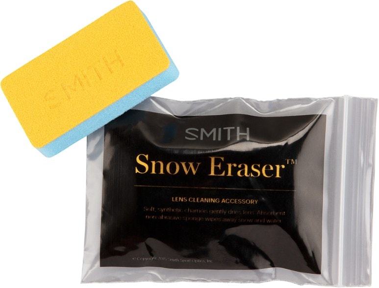 Ski goggle snow cleaning eraser being used on goggles in a snowy environment.
