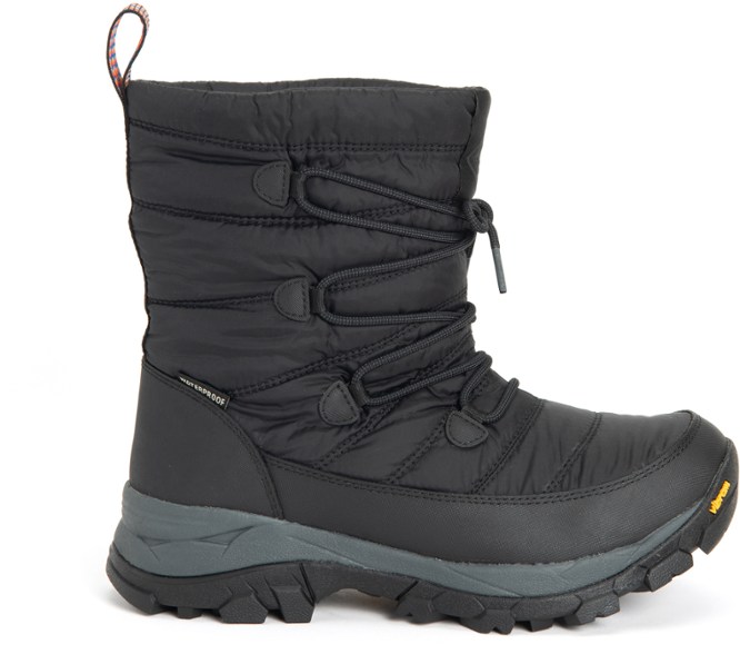 Arctic Shield Women's Insulated Waterproof Boots in snowy landscape, showcasing high traction outsole.