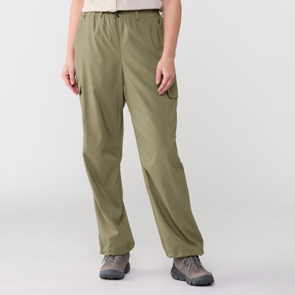 Columbia Women's Insect Shield Cargo Pants showcased in a hiking environment, highlighting insect protection features.