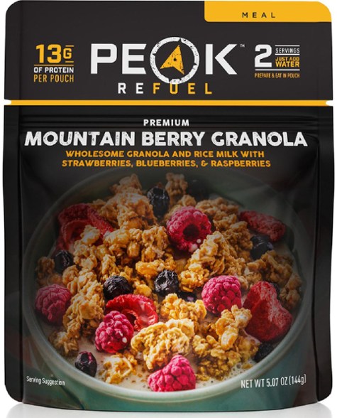 Peak Refuel Mountain Berry Delight Granola in a hiking setting, showcasing its lightweight packaging.