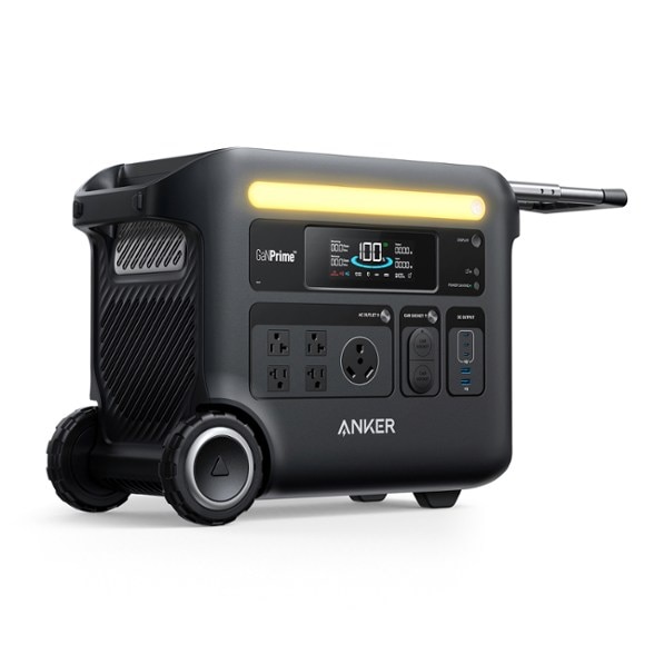 SOLIX F2600 Portable Power Station with solar panels in a camping setting.
