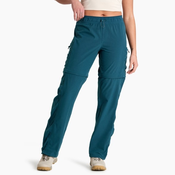 KÜHL Women's Quick-Dry Convertible Pants showcased on a hiking trail, highlighting their lightweight design.