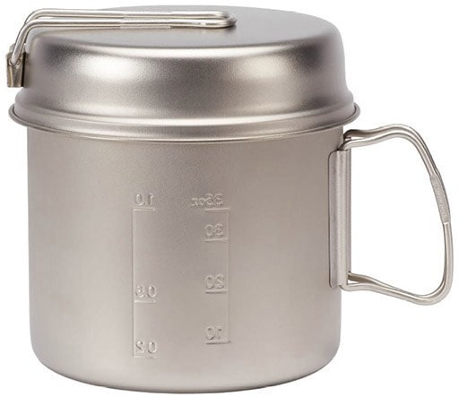 Trek 900 titanium pot and frypan set displayed on a camping table.