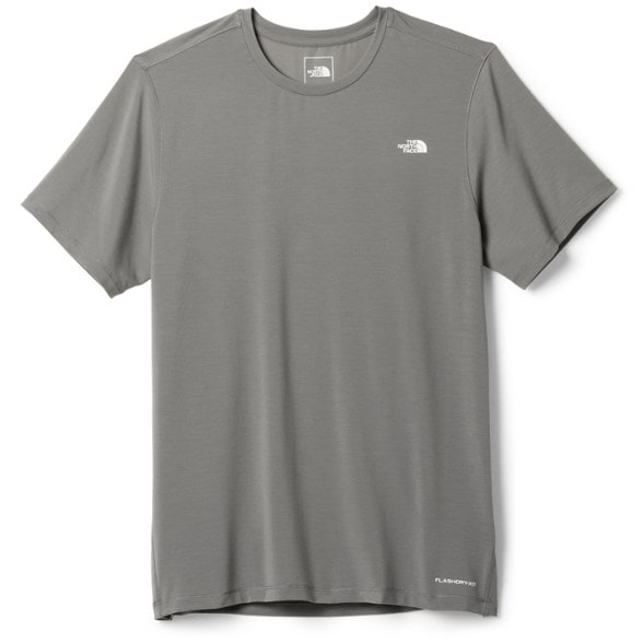 Front view of men's adventure shirt on model hiking a summer trail