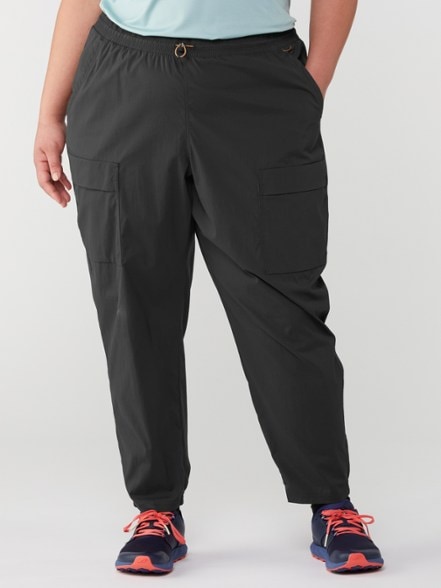 TrailBlazer Women's Pull-On Hiking Pants in action during a hike, highlighting the water-repellent fabric and six pockets.