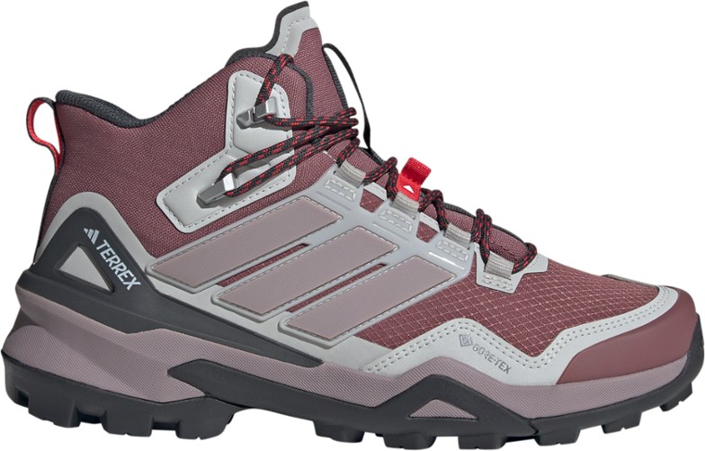 Side view of Terrex Skychaser women's GORE-TEX hiking boots on a rocky trail.