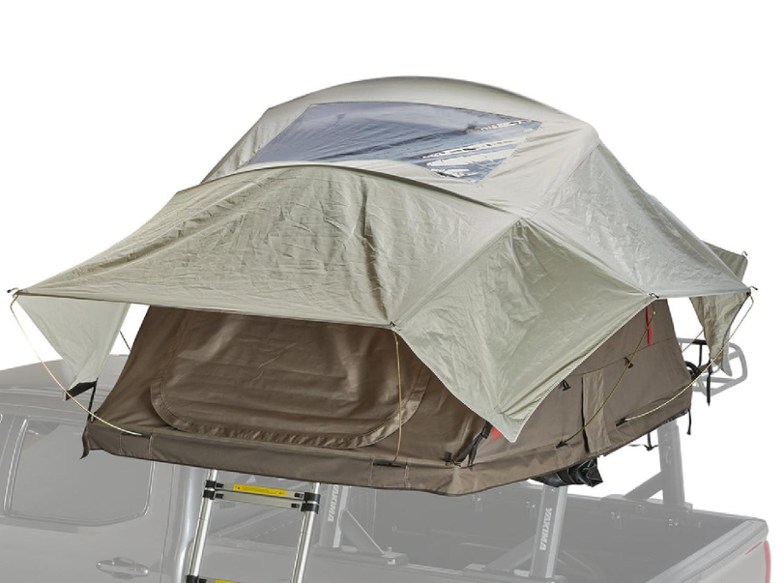 SkyRise HD Compact Roof Top Tent set up in a forest, showcasing its spacious interior and large windows.