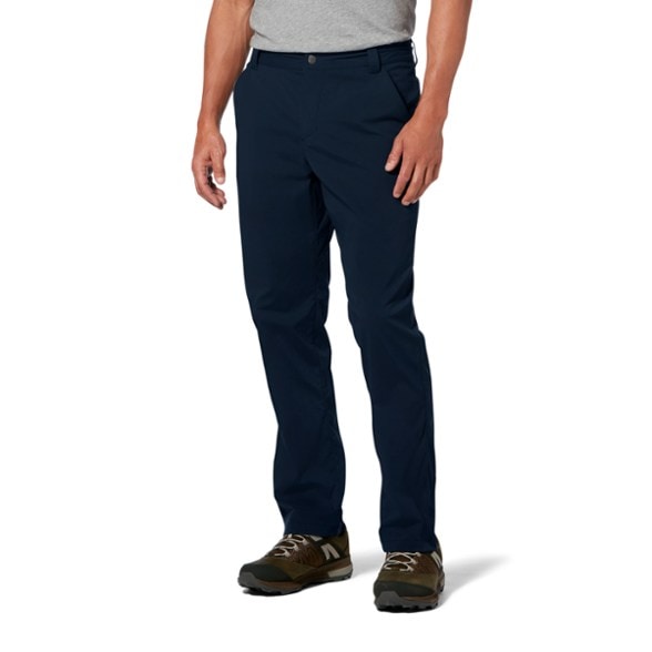 Men wearing TrailFlex Vent-Tech lightweight hiking pants while crossing a stream in sunny weather