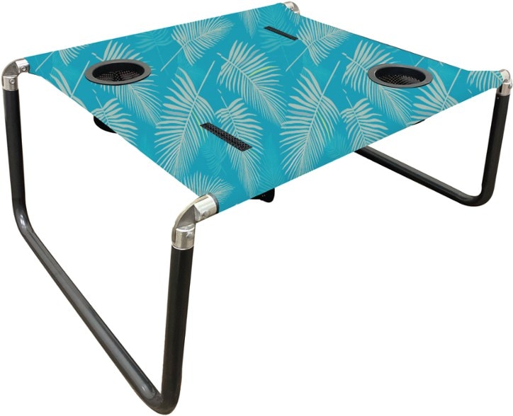 Portable beach table on sandy beach with drinks in cup holders.