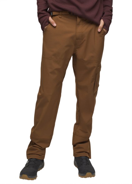 Front view of Zion TrailShield men's hiking pants worn on rocky terrain.