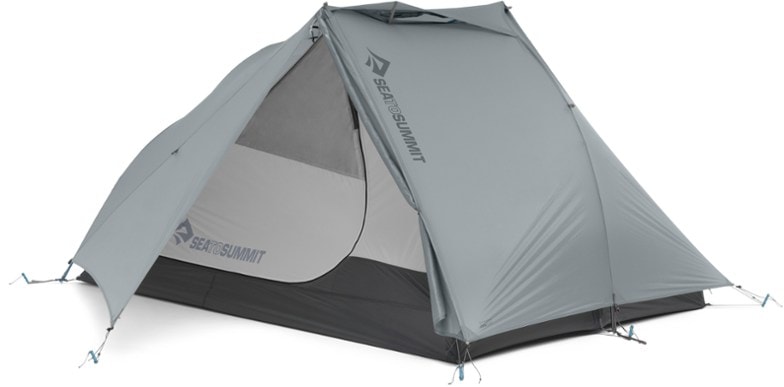 Sea to Summit Alto TR2 Plus tent set up in a lush forest, showcasing its spacious interior and ventilation features.