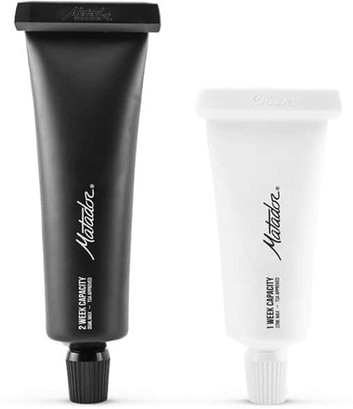 Eco-friendly travel toothpaste tubes set on a bathroom counter.