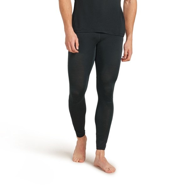 Front view of men's thermal leggings worn during a cold weather run, showing breathable panel placement.
