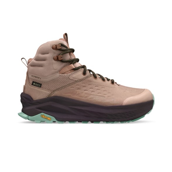 Altra Olympus 6 Mid GTX Women's hiking boots in rugged terrain, showcasing waterproof features.