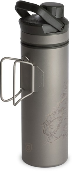 Titanium UltraPress water purifier bottle in a camping setting, showcasing its portability and sleek design.