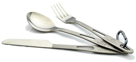 Titanium knife, fork, and spoon set displayed on a picnic table
