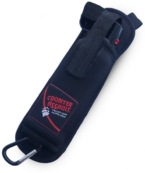 Flexible neoprene bear spray holster attached to a backpack, showcasing its MOLLE straps.