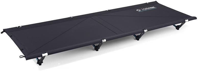 Helinox Max Comfort Camping Cot displayed in a forest setting, emphasizing its lightweight design.