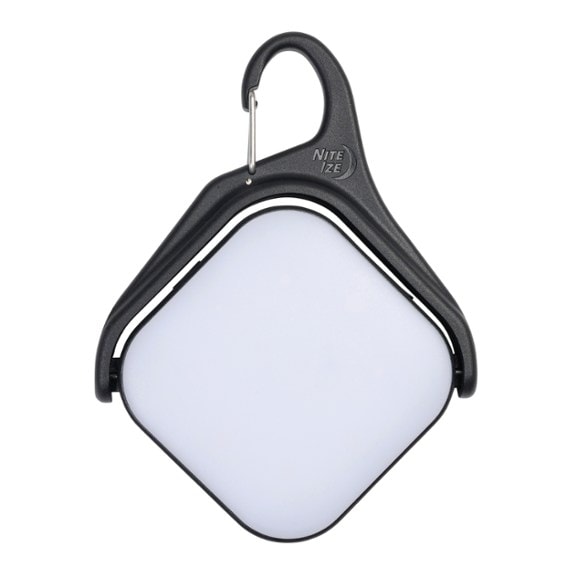 Top-down view of RevolveX solar lantern clipped to a hiking backpack with natural sunlight hitting the panel