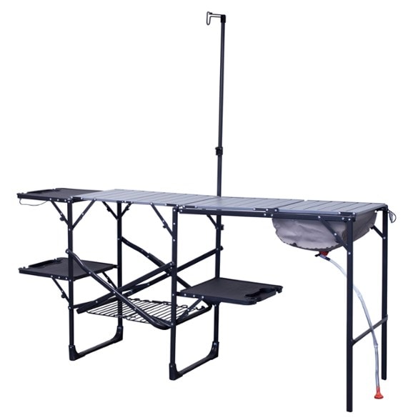 Portable camp kitchen setup with soft-shell sink and lantern pole.
