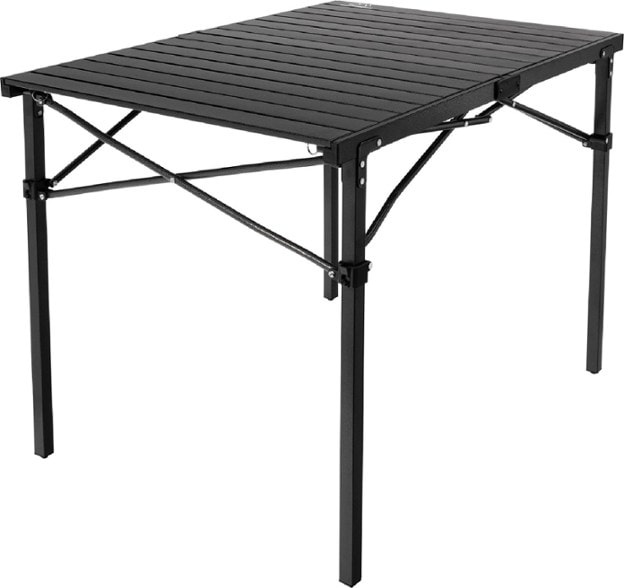 Portable roll-top camping table set up next to a campfire, demonstrating its lightweight and sturdy build.