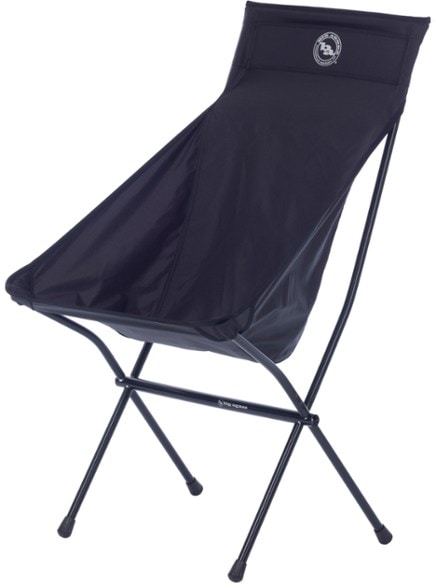 Front view of Ultimate Outdoor Camp Chair in a campsite setting, highlighting its tall back and wide seat.