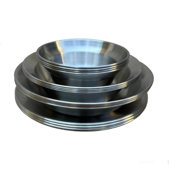 Overhead view of stackable stainless steel dishes from the TrailMate camping tableware set neatly packed in a canvas bag
