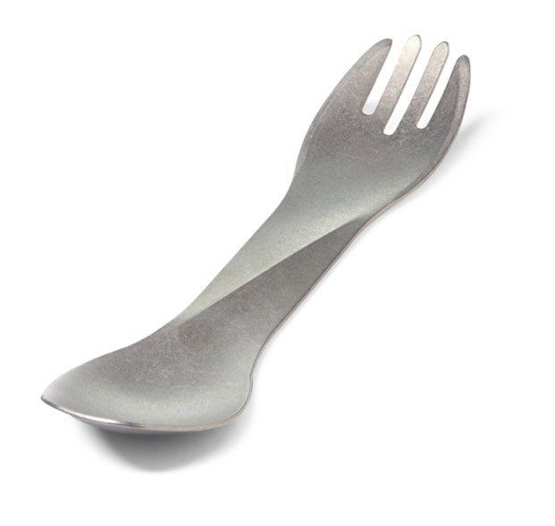 UltraLite Titanium Spork held outdoors against a scenic backdrop, showcasing its lightweight design.