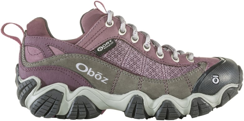 Oboz Firebrand II women's hiking shoes in a natural outdoor setting, showcasing durability and comfort.