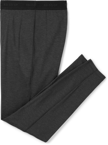 Front view of SummitFlex midweight base layer pants for hiking in black color, shown with outdoor boots