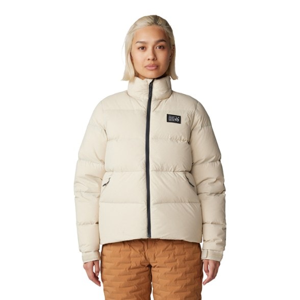 Summit Warmth Women's Down Jacket in action on a snowy trail, showcasing its warmth and functionality.