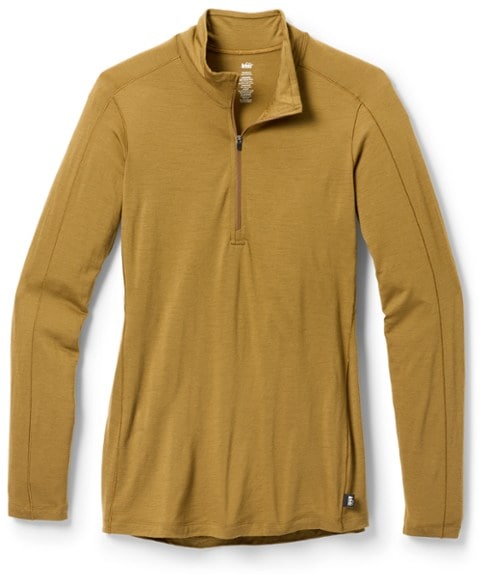 REI Co-op women's long sleeve base layer top in action on a hiking trail, showcasing its flexibility and style.
