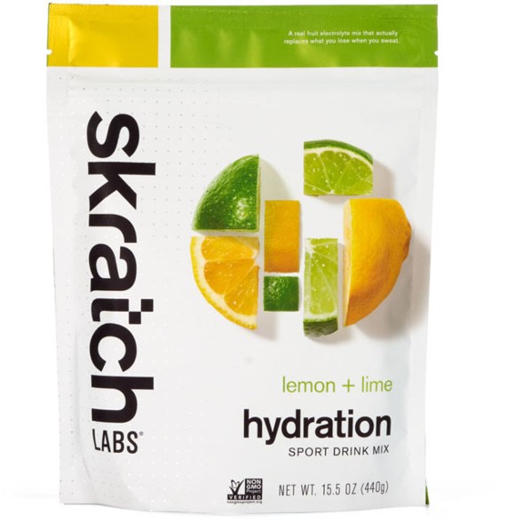 Pure Electrolyte Hydration Mix packet with fresh fruit in the background.