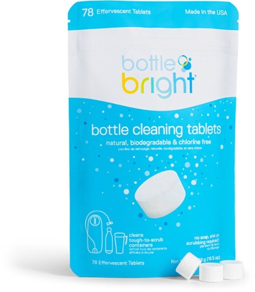 PurePop bottle cleaning tablets dissolving in a glass of warm water