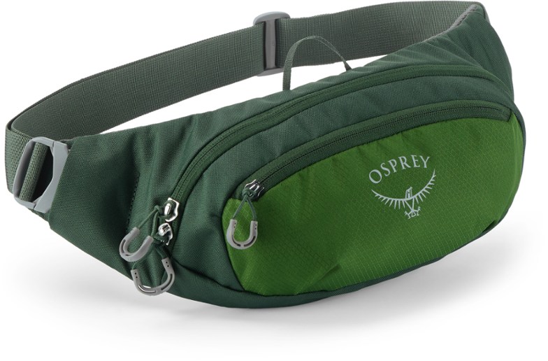 Osprey Daylite waist pack worn by a hiker on a trail, featuring a zippered front pocket.