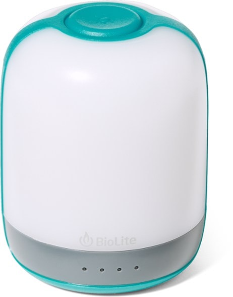 NatureGlow 250 lantern showcasing its vibrant color modes in a camping setting.