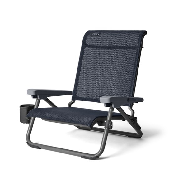 Heavy duty reclining beach chair with UV-resistant FlexGrid fabric in a sunny beach setting