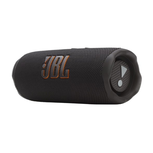 JBL Flip 7 speaker in a garden, demonstrating its waterproof feature.