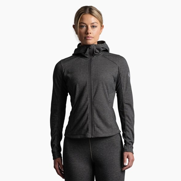 KÜHL women's technical fleece hoodie in action during an outdoor hike, showcasing warmth and style.