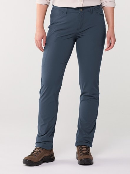Eco-Ferrosi Women's Hiking Pants in action on a mountain trail, demonstrating flexibility and comfort.