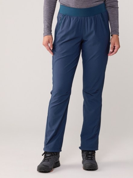 Columbia Women's Leslie Falls Pants shown in a sunny hiking environment, highlighting their sun protection features.